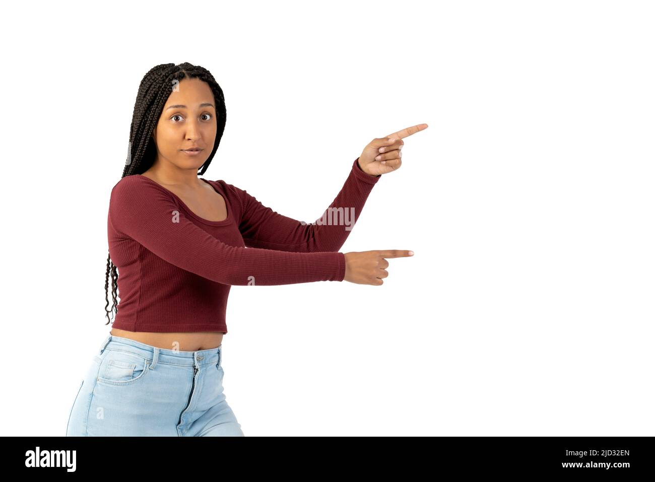 Young black woman with casual clothing in white background pointing to the right Stock Photo