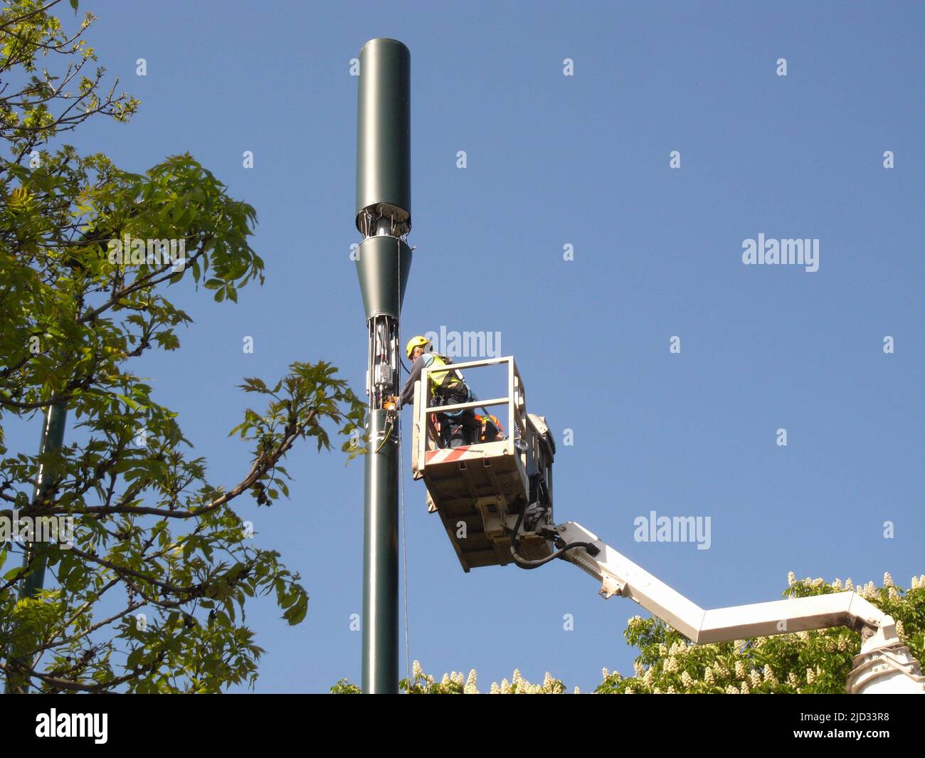 Workman using cherry picker while fitting a 5g Telecoms Mast London Stock Photo