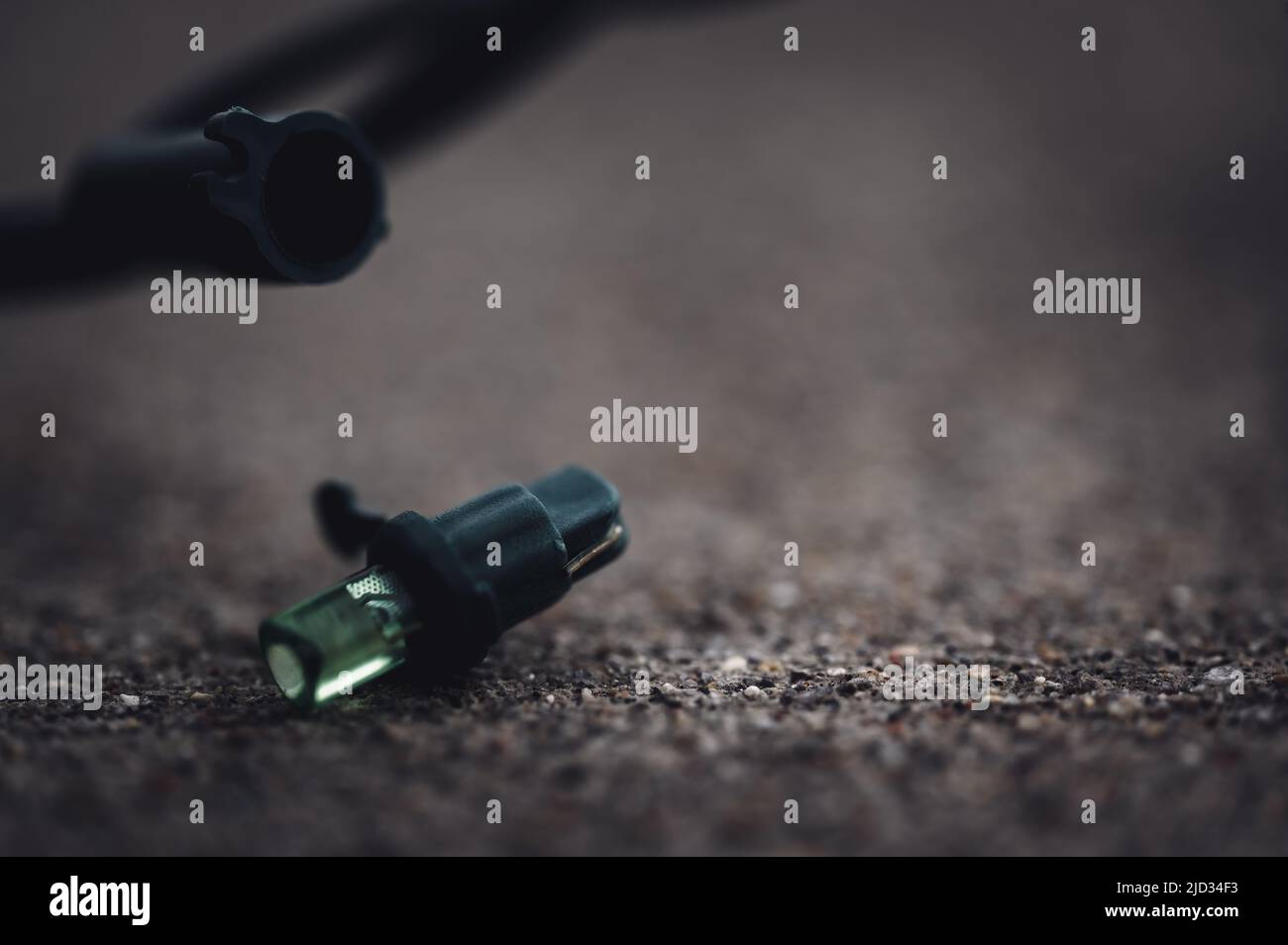 Focus on replacement bulb for a string of Christmas lights to repair a