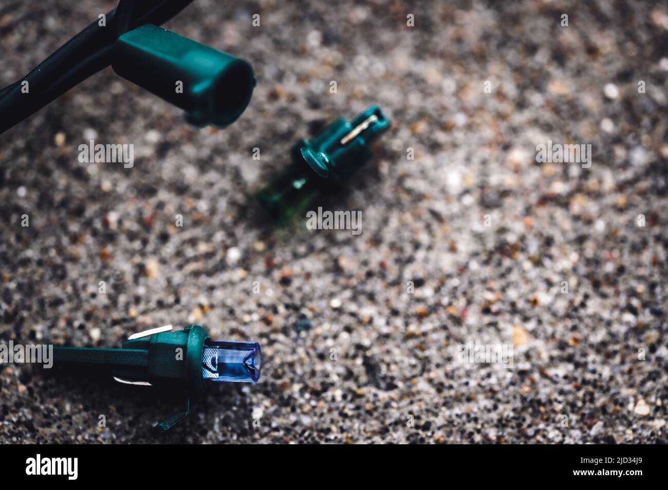 Focus on replacement bulb for a string of Christmas lights to repair a