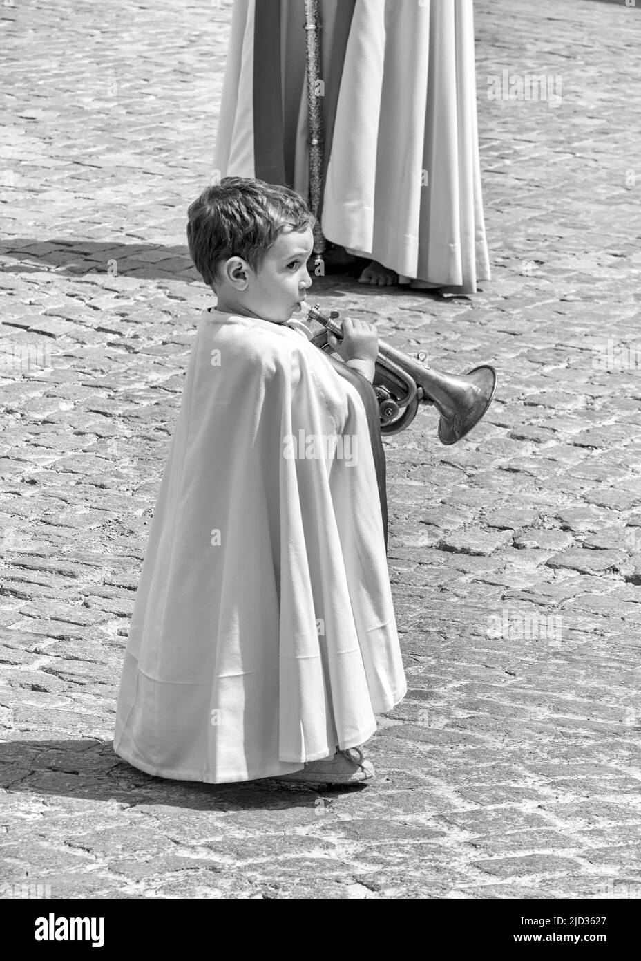 A boy with a trumpet parading through the streets of Ubeda during the celebration of the traditional Semana Santa (Holy Week). Stock Photo