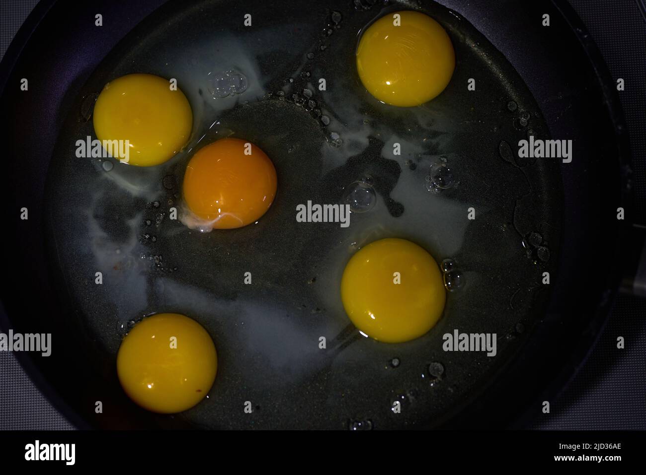 Five eggs in a frying pan in olive oil. High quality photo Stock Photo