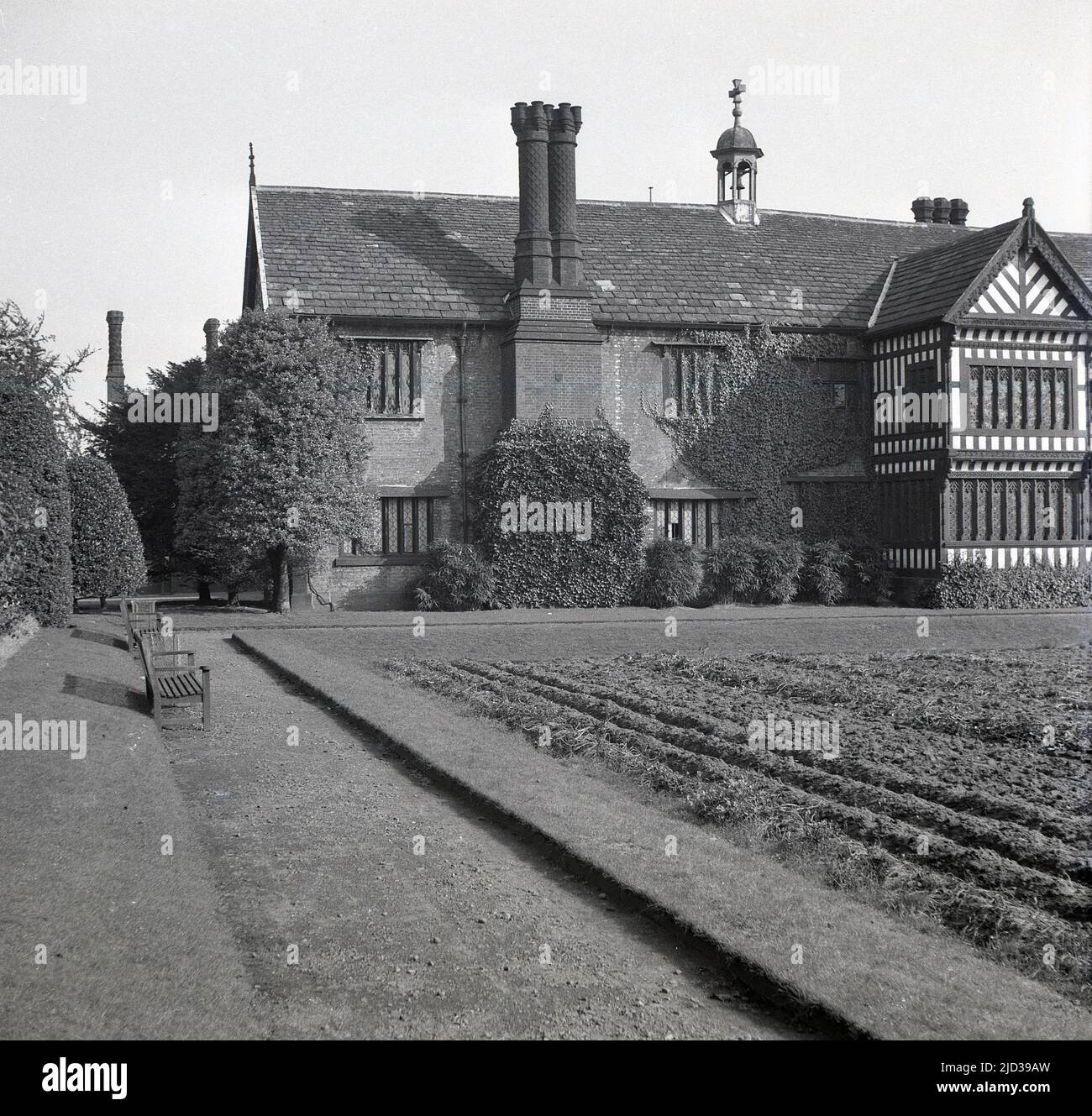 1940s, historical, South facade, the rear of Bramall Hall, Stockport, England, UK. A timber-framed Tudor manor house that dates back to the 14th century, with later additions, the house and surrounding parkland was acquired by the local authority in 1935 and became a museum. The Davenport family, which it is believed built the house, held the manor for over 500 years. Stock Photo