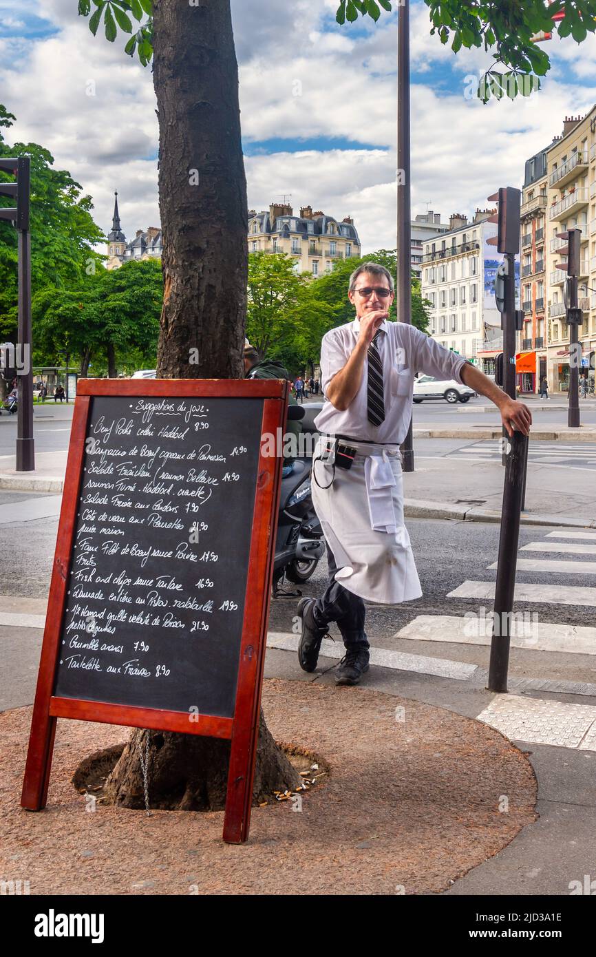 Waiter at Le Dalou bar restaurant , Place de la Nation, Paris 12th, having a smoke break. Stock Photo
