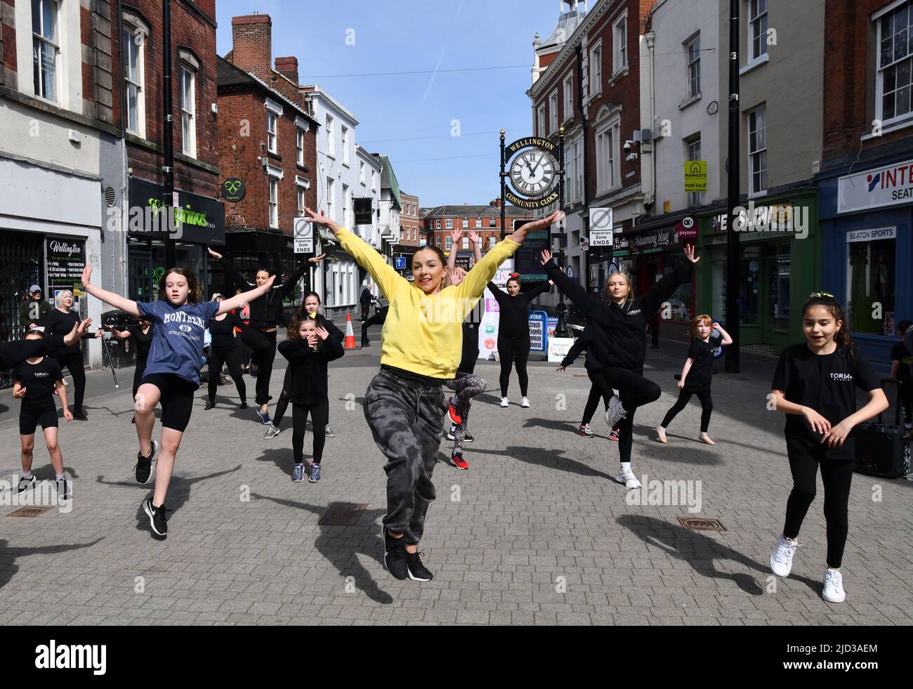 Ballet school teacher and pupils dancing in the street Britain, Uk Stock Photo
