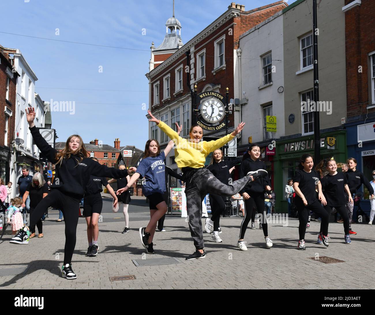 Ballet school teacher and pupils dancing in the street Britain, Uk Stock Photo
