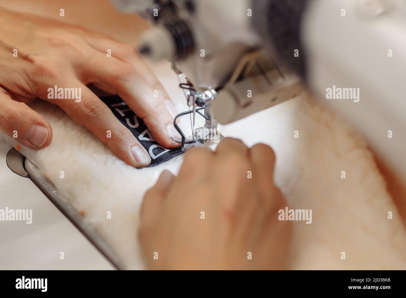 sewing machine scribbling fabric. tailoring at the factory Stock Photo