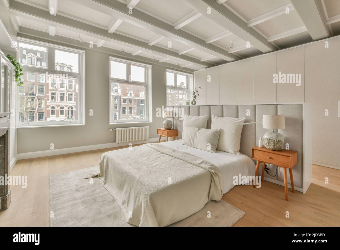 Spacious bright bedroom with a vintage bedside tables, white wardrobes