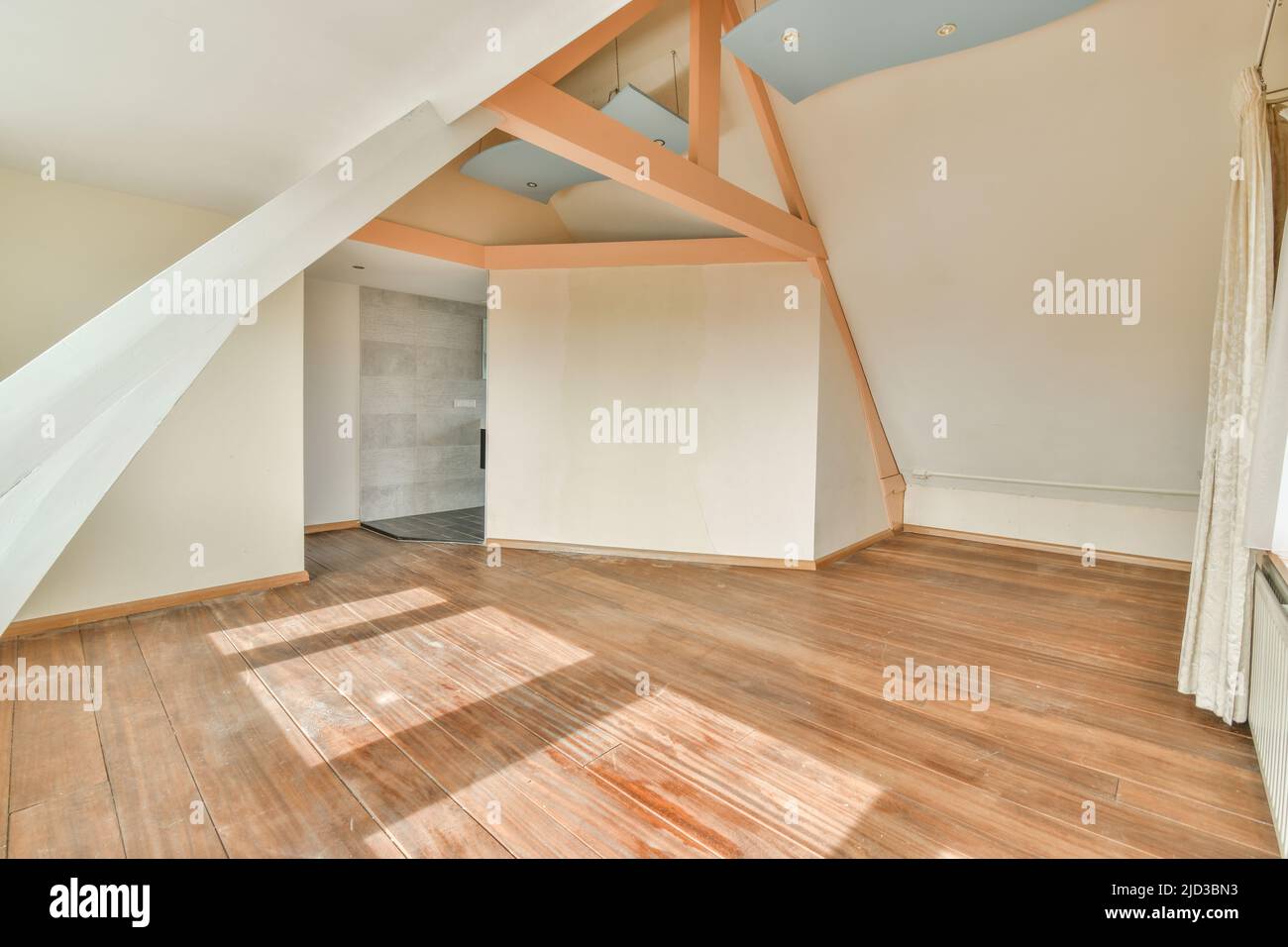 Attic Radiator Plastic window and radiator on white wall in empty light attic room at ...