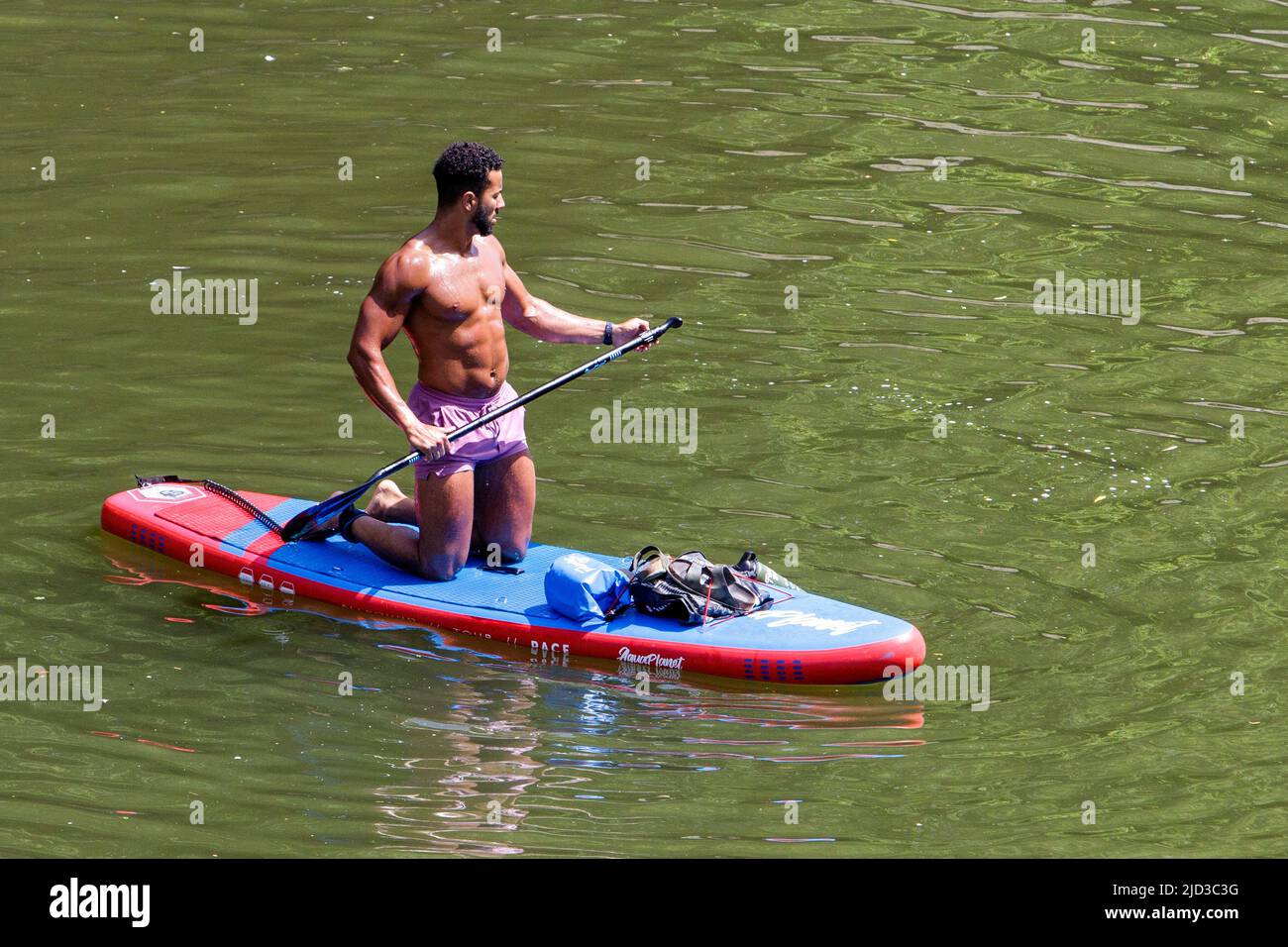 Bath, UK, 17th June, 2022. With many parts of the UK enjoying another very hot and sunny day, a paddleboarder is pictured enjoying the hot weather on the River Avon in front of Pulteney Bridge. Credit: Lynchpics/Alamy Live News Stock Photo