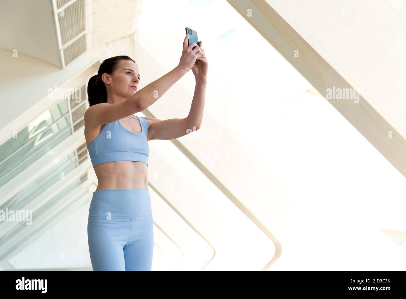 Attractive sporty woman taking a selfie on her smartphone. Stock Photo
