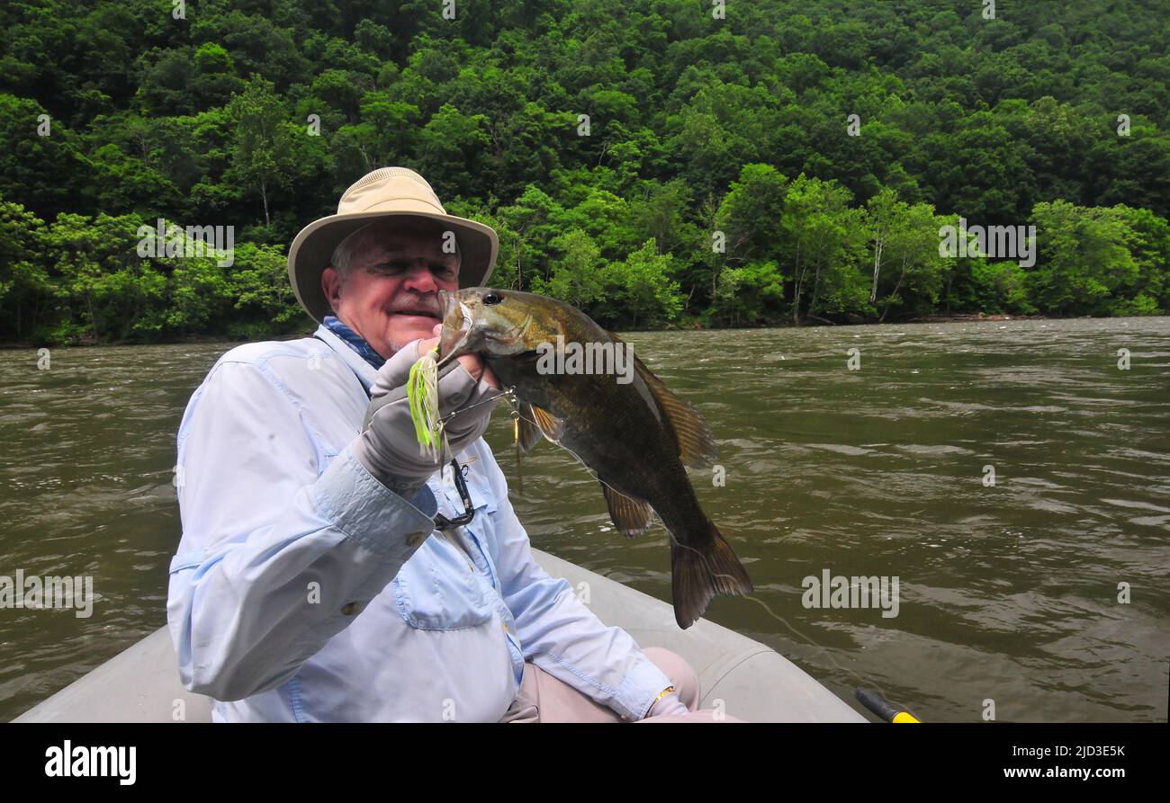 Larry Larsen checks out a nice size smallmouth bass that fell for