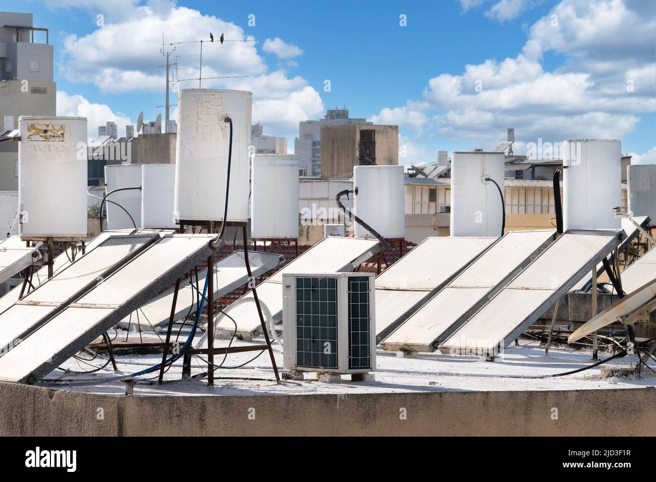 A lot of solar water heating systems installed on the roof of the house in Israel Stock Photo