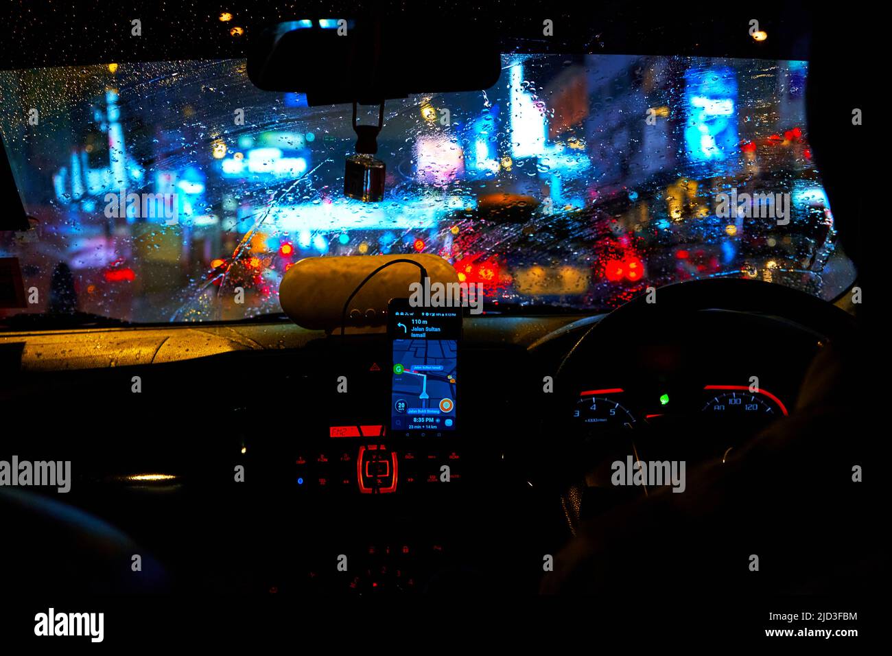 interior of a car driving night rainy city. blurred city lights. Kuala ...