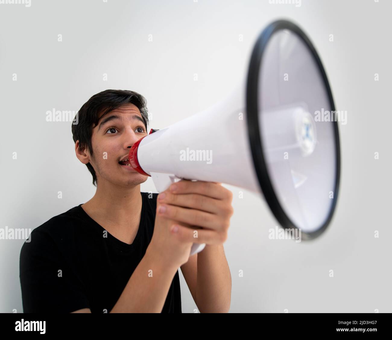 Teenage boy on white background with a megaphone. High quality photo Stock Photo