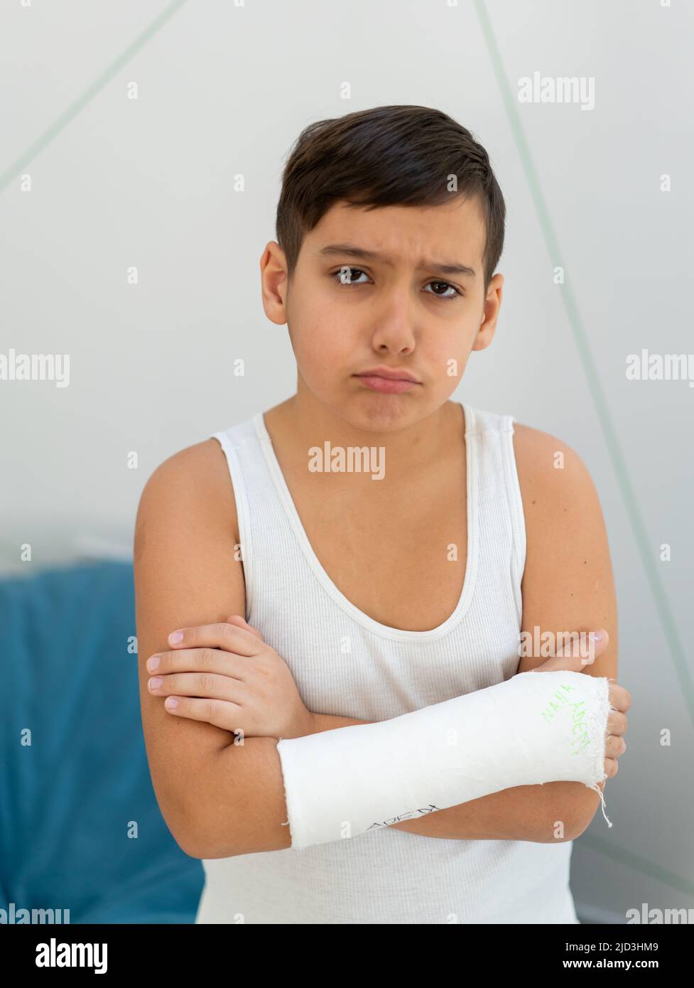 Boy keeps broken arm in gypsum, plaster arm, accident at home , injury
