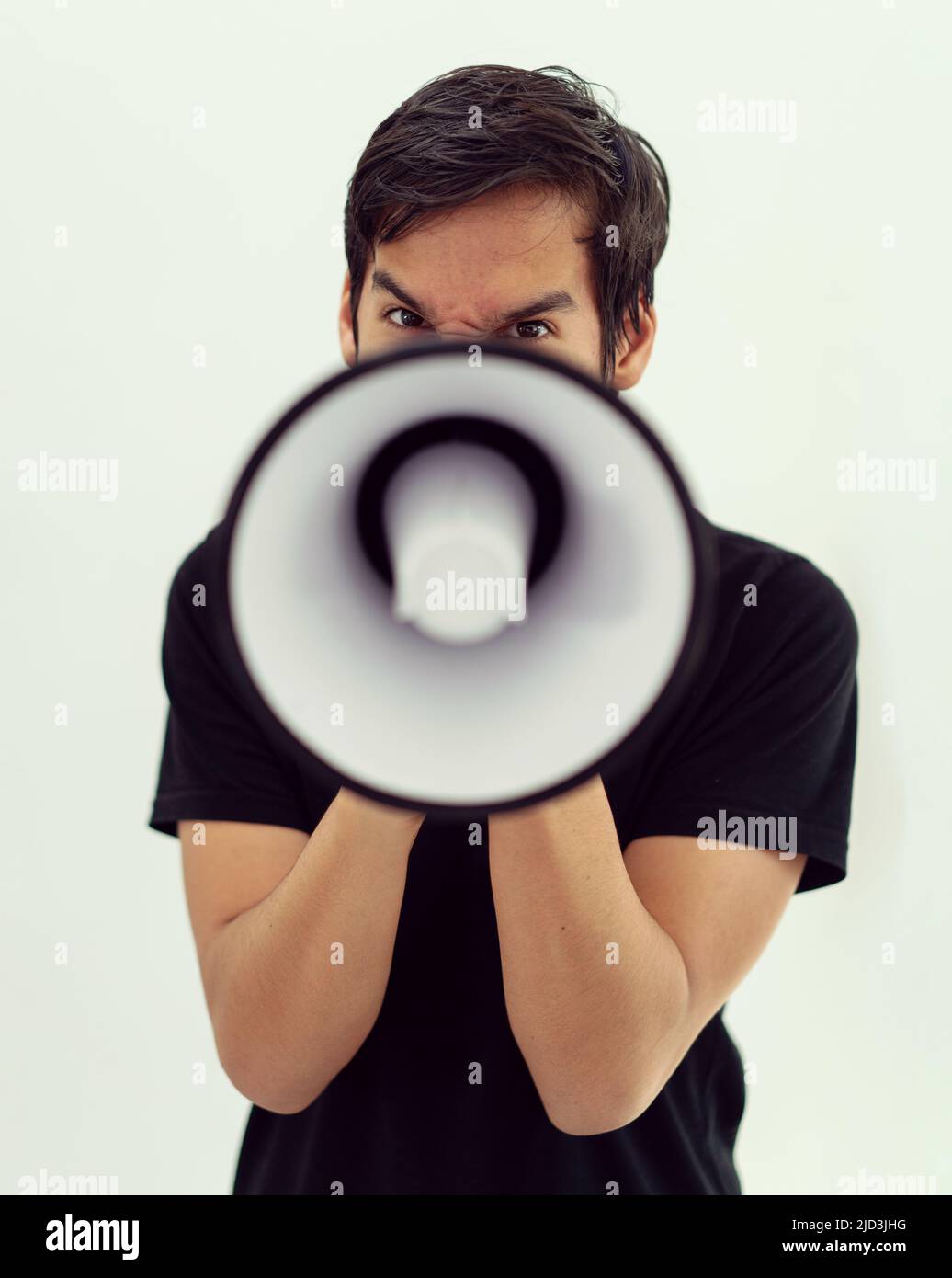 Teenage boy on white background with a megaphone. High quality photo Stock Photo