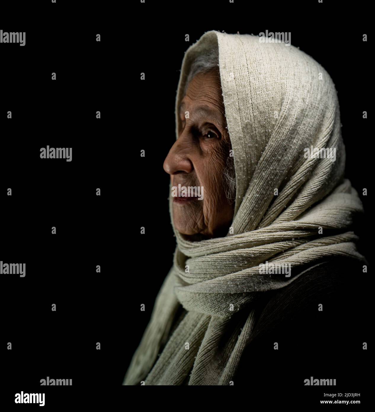 Elderly woman with kerchief, studio portrait. High quality photo Stock Photo