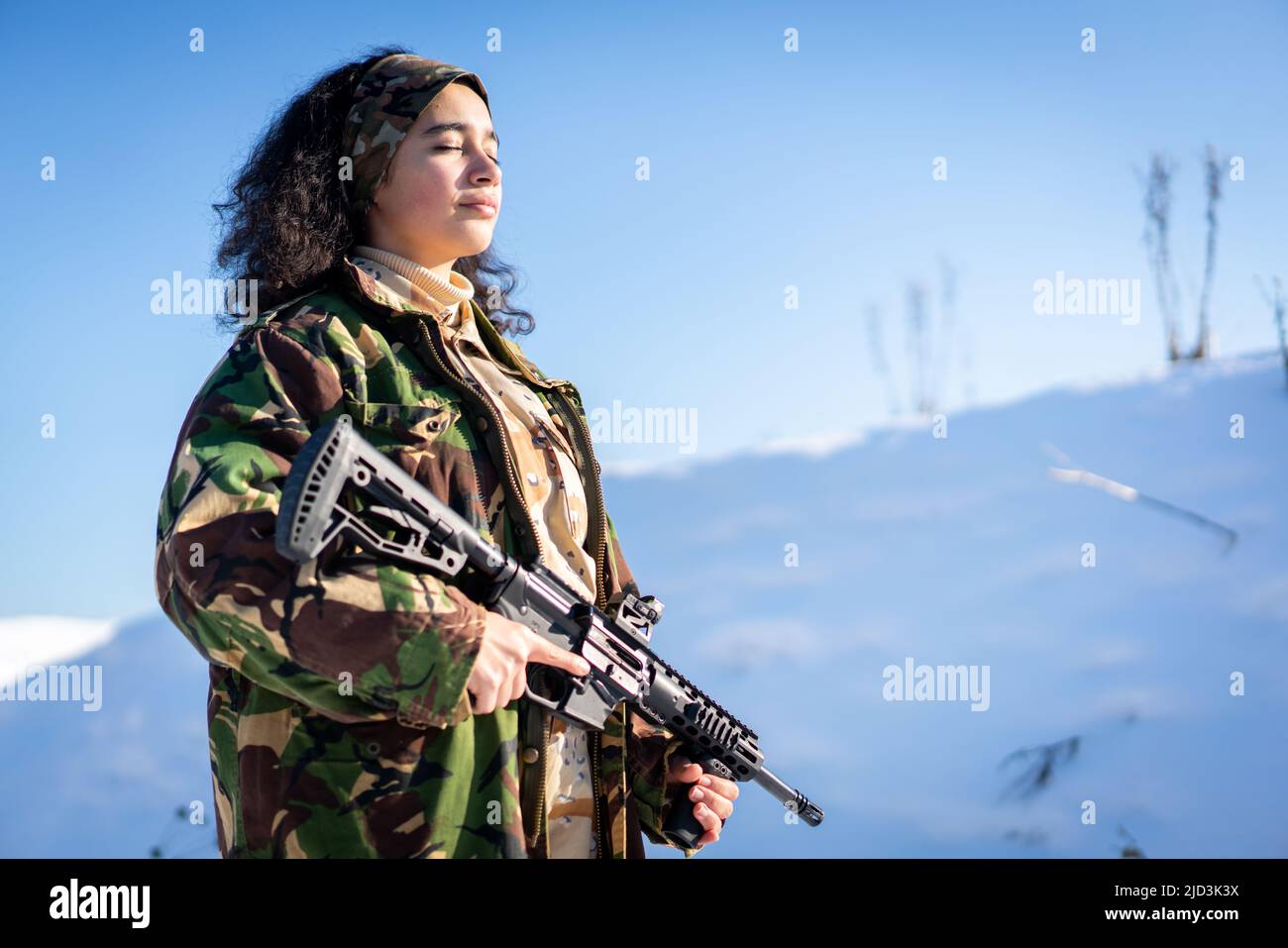 Young Female Soldier In Military Uniform On Winter Snow. High quality photo Stock Photo