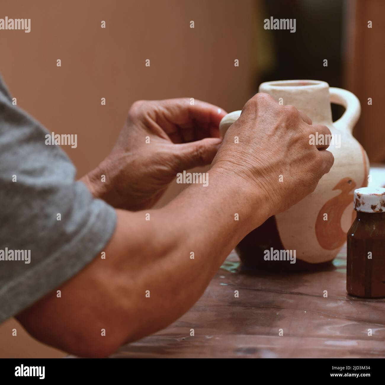 Close up view of an elderly man molding a clay block  and making ceramic pot Stock Photo