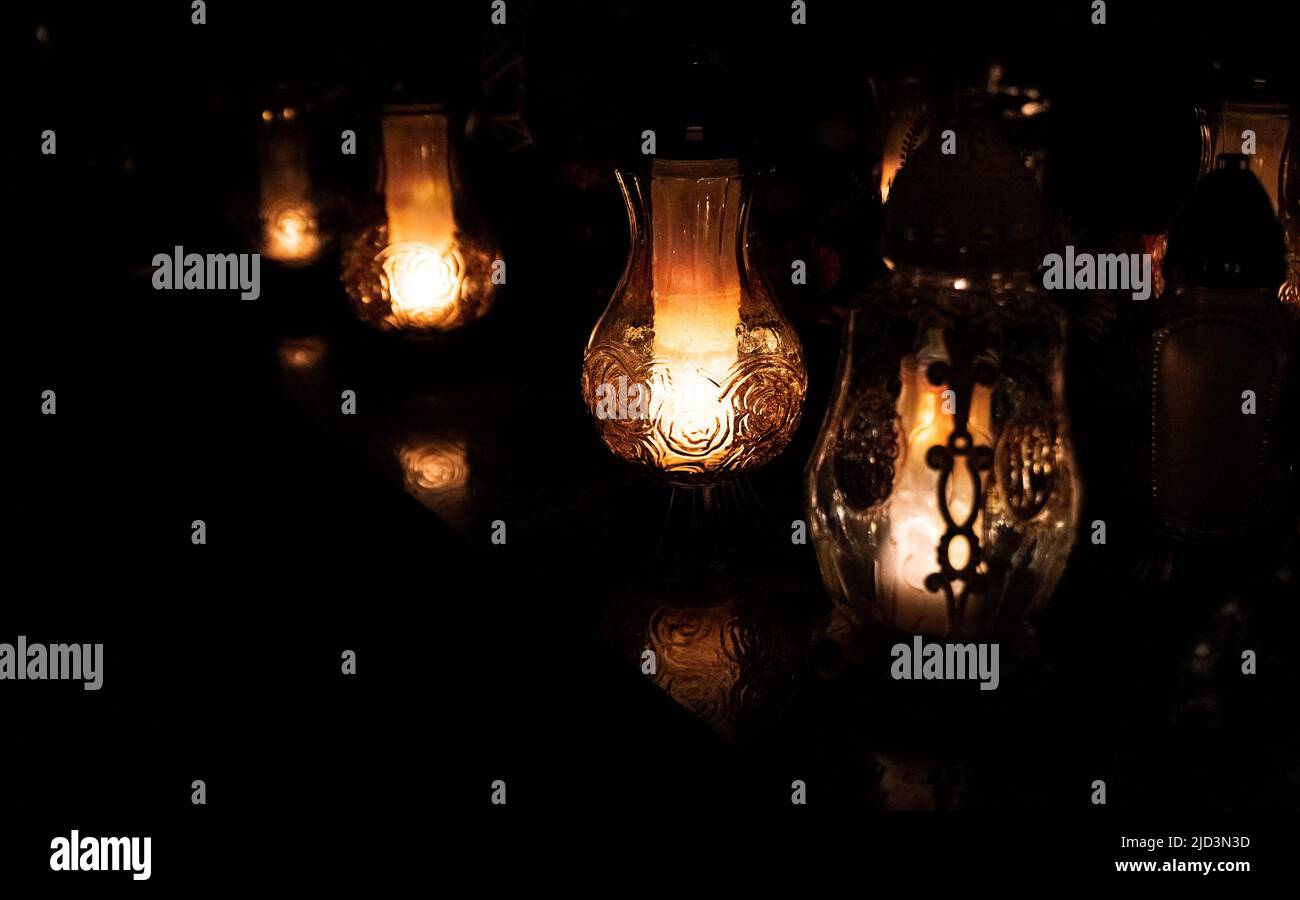 All Saints Day. Night at the cemetery. Candle flame at night on the