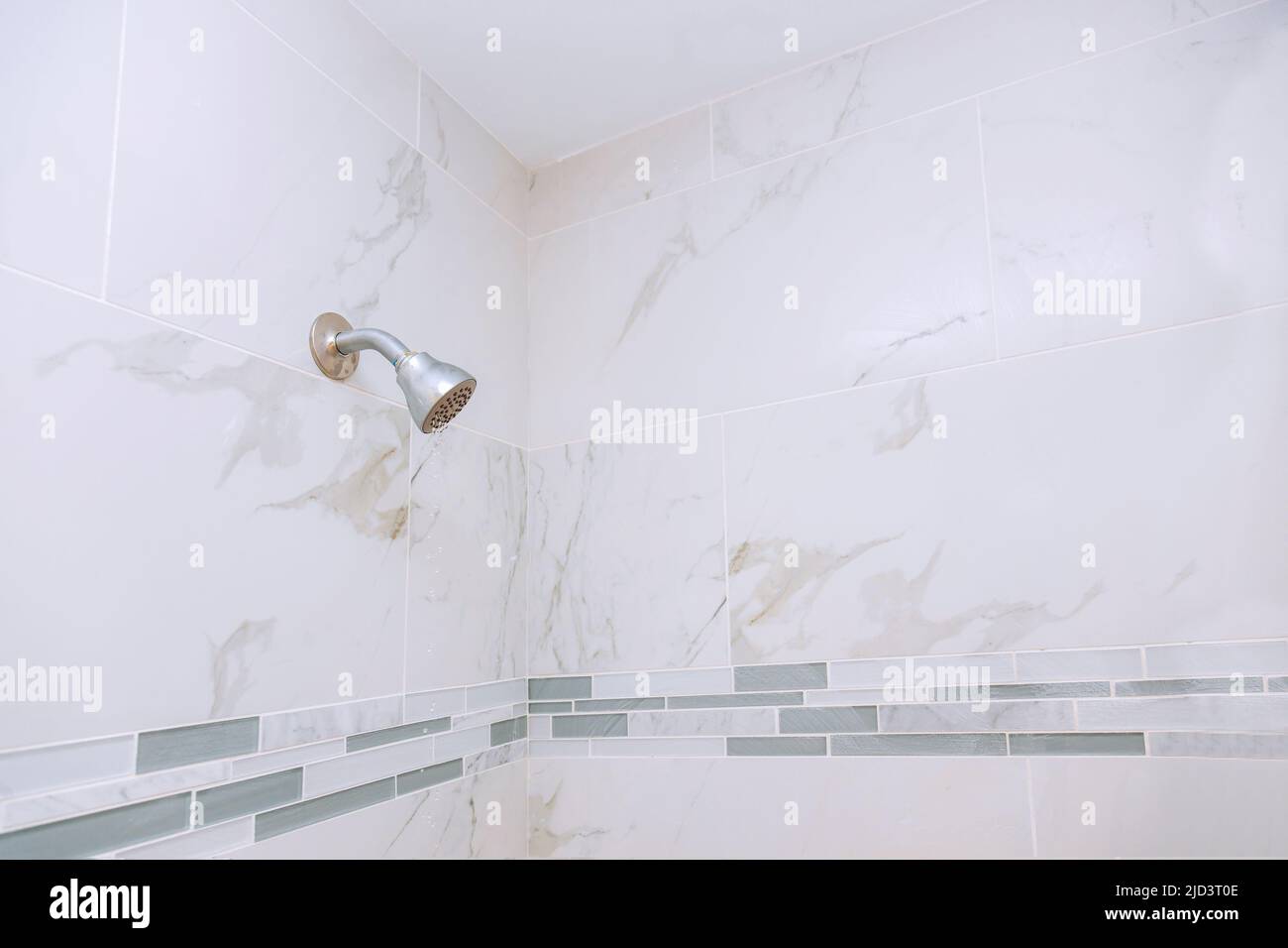New shower head in bathroom with water drops flowing Stock Photo Alamy