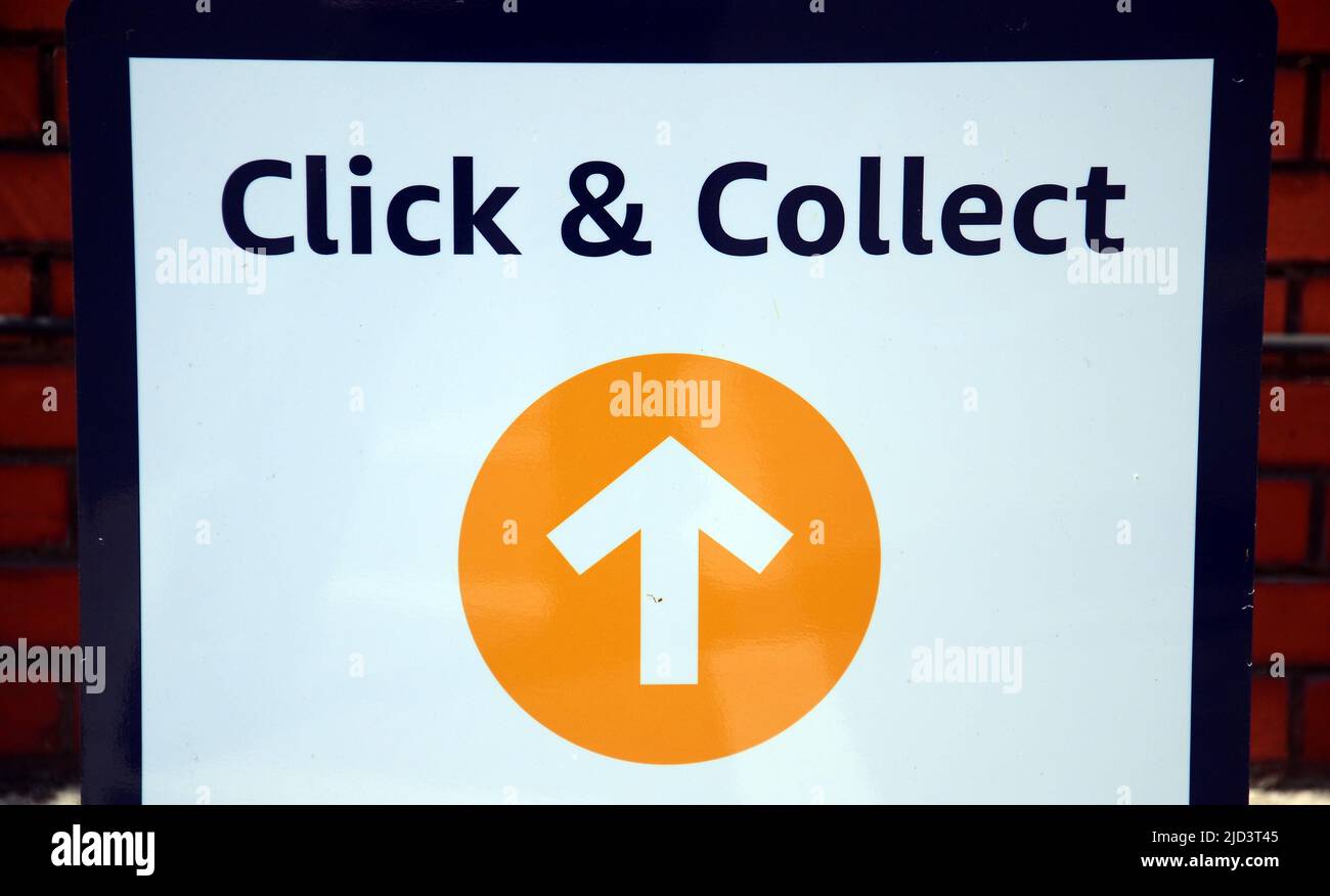A Click and collect sign with an arrow in Manchester, England, United