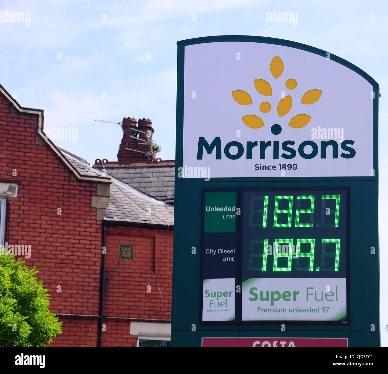 Exterior sign of a Morrisons garage shows fuel prices in Chorltoncum