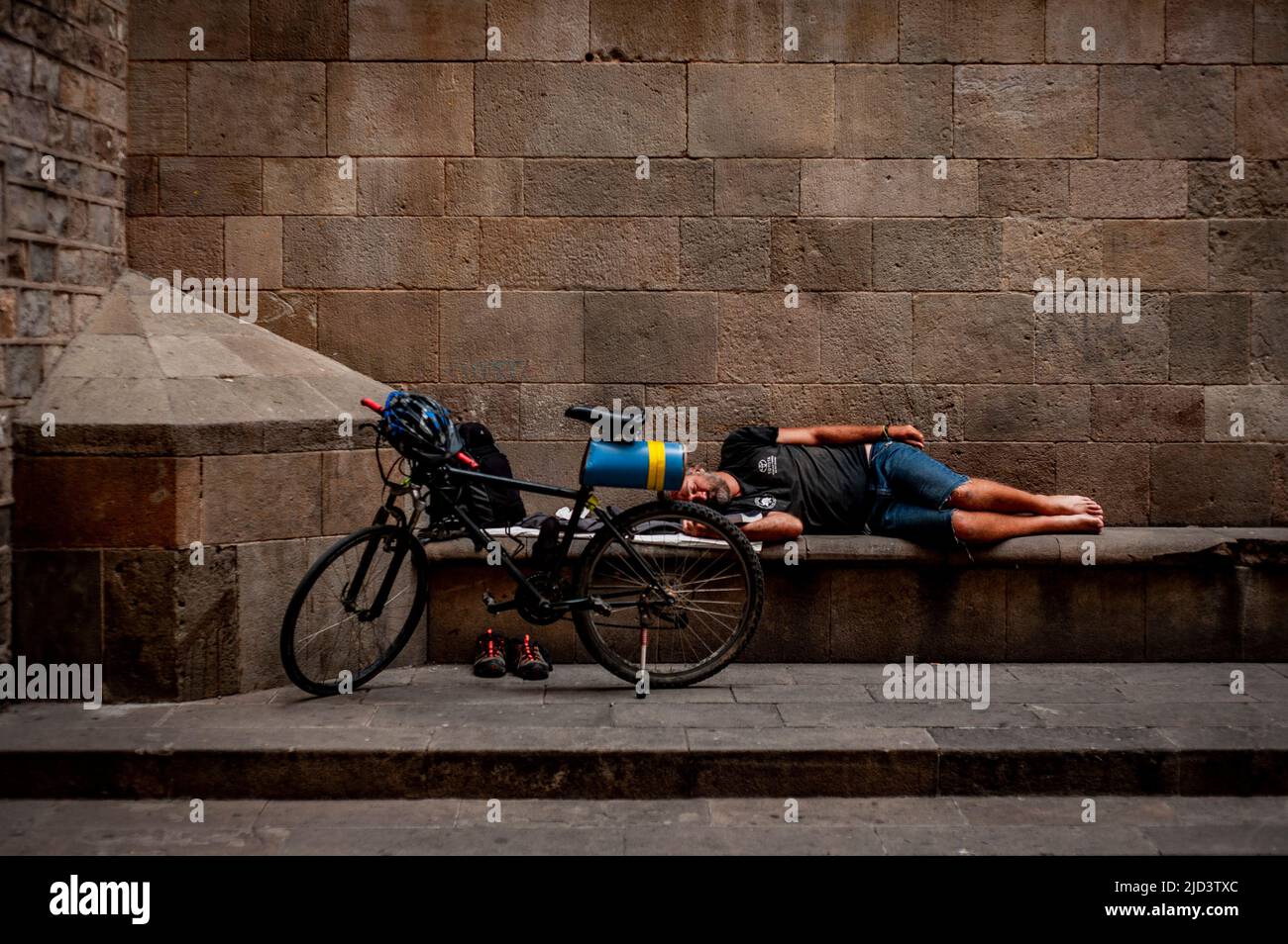 Barcelona, Spain. 17th June, 2022. June 17, 2022, Barcelona, Spain: A man sleeps in the Gothic Quarter of Barcelona as a heat wave is underway in parts of Western Europe, with widespread temperatures near or above 104 degrees Fahrenheit (40 Celsius) expected through the weekend. Current heatwave brings abnormally high temperatures for June days in Spain. Credit:  Jordi Boixareu/Alamy Live News Credit:  Jordi Boixareu/Alamy Live News Stock Photo