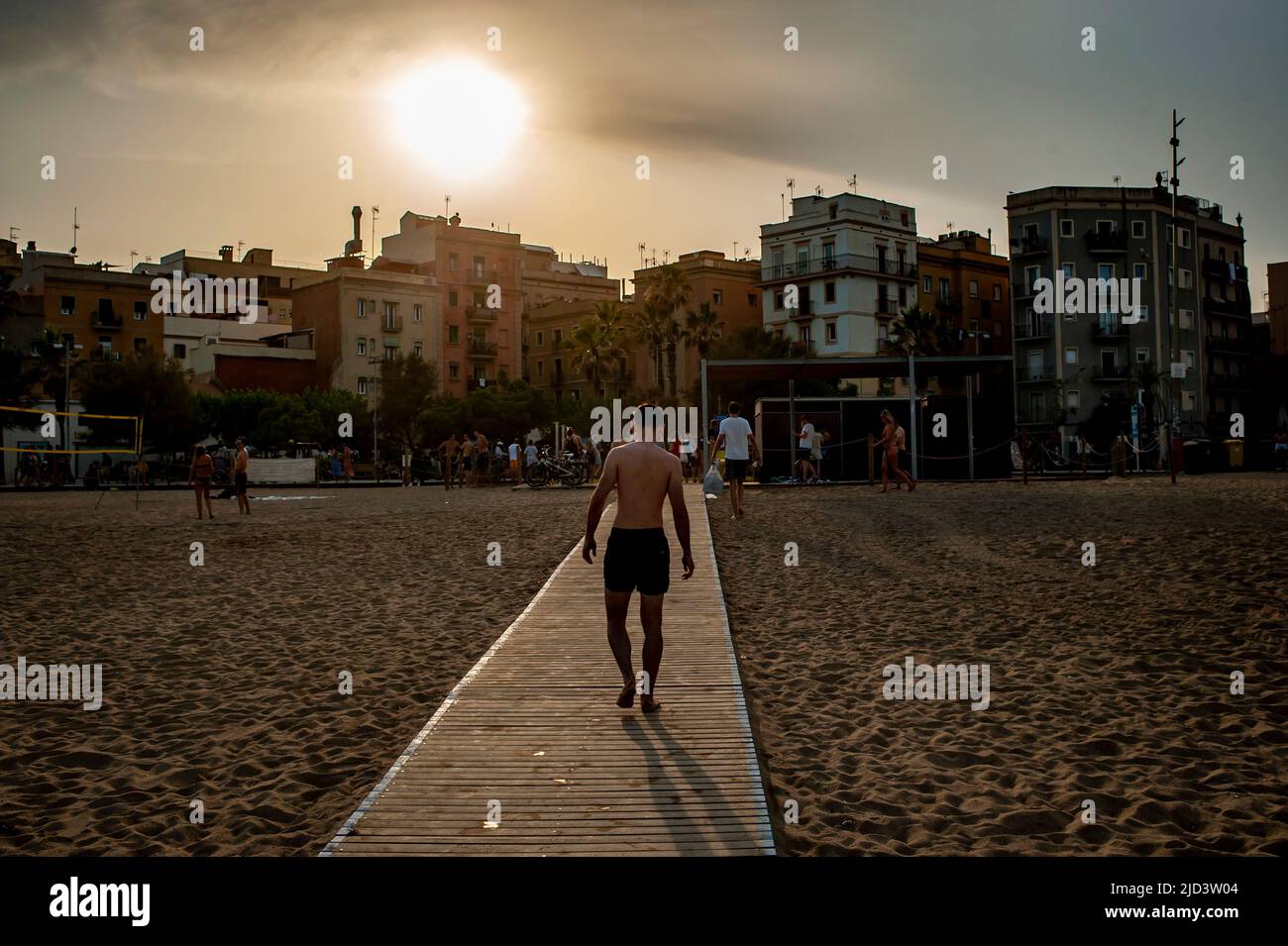Barcelona, Spain. 17th June, 2022. June 17, 2022, Barcelona, Spain: Man walks a footpath at the Barceloneta beach in Barcelona as a heat wave is underway in parts of Western Europe, with widespread temperatures near or above 104 degrees Fahrenheit (40 Celsius) expected through the weekend. Current heatwave brings abnormally high temperatures for June days in Spain. Credit:  Jordi Boixareu/Alamy Live News Credit:  Jordi Boixareu/Alamy Live News Stock Photo