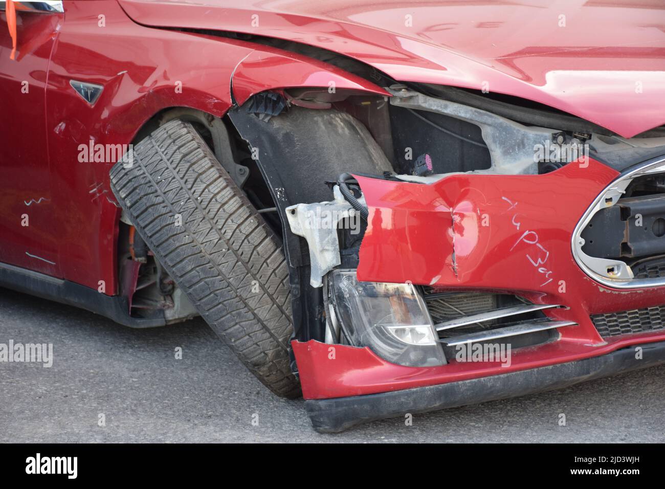 Crashed red electric car Stock Photo