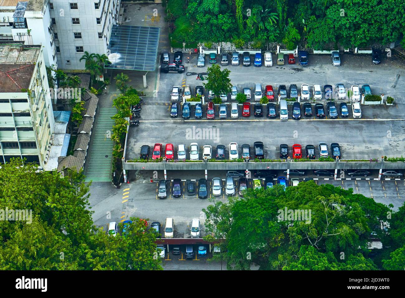 View from above on double floor parking near office building. Kuala