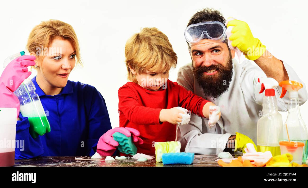 Family cleaning together. Mother and father teach little son clean up. Child boy playing with foam. Stock Photo