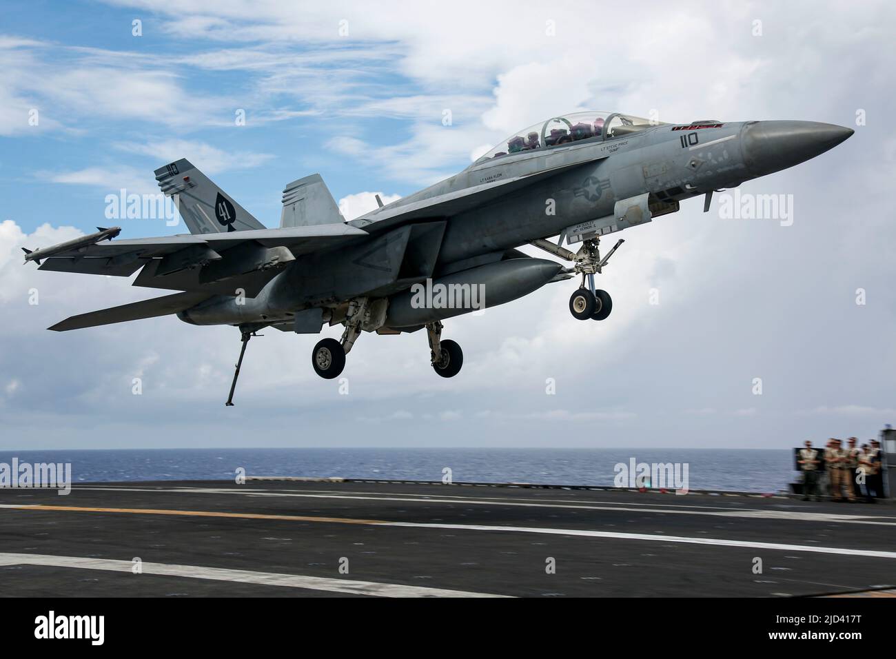 PHILIPPINE SEA (June 15, 2022) An F/A-18F Super Hornet, assigned to the 'Black Aces' of Strike Fighter Squadron (VFA) 41, prepares to make an arrested landing on the flight deck of the Nimitz-class aircraft carrier USS Abraham Lincoln (CVN 72). Abraham Lincoln Strike Group is on a scheduled deployment in the U.S. 7th Fleet area of operations to enhance interoperability through alliances and partnerships while serving as a ready-response force in support of a free and open Indo-Pacific region. (U.S. Navy photo by Mass Communication Specialist 3rd Class Michael Singley) Stock Photo