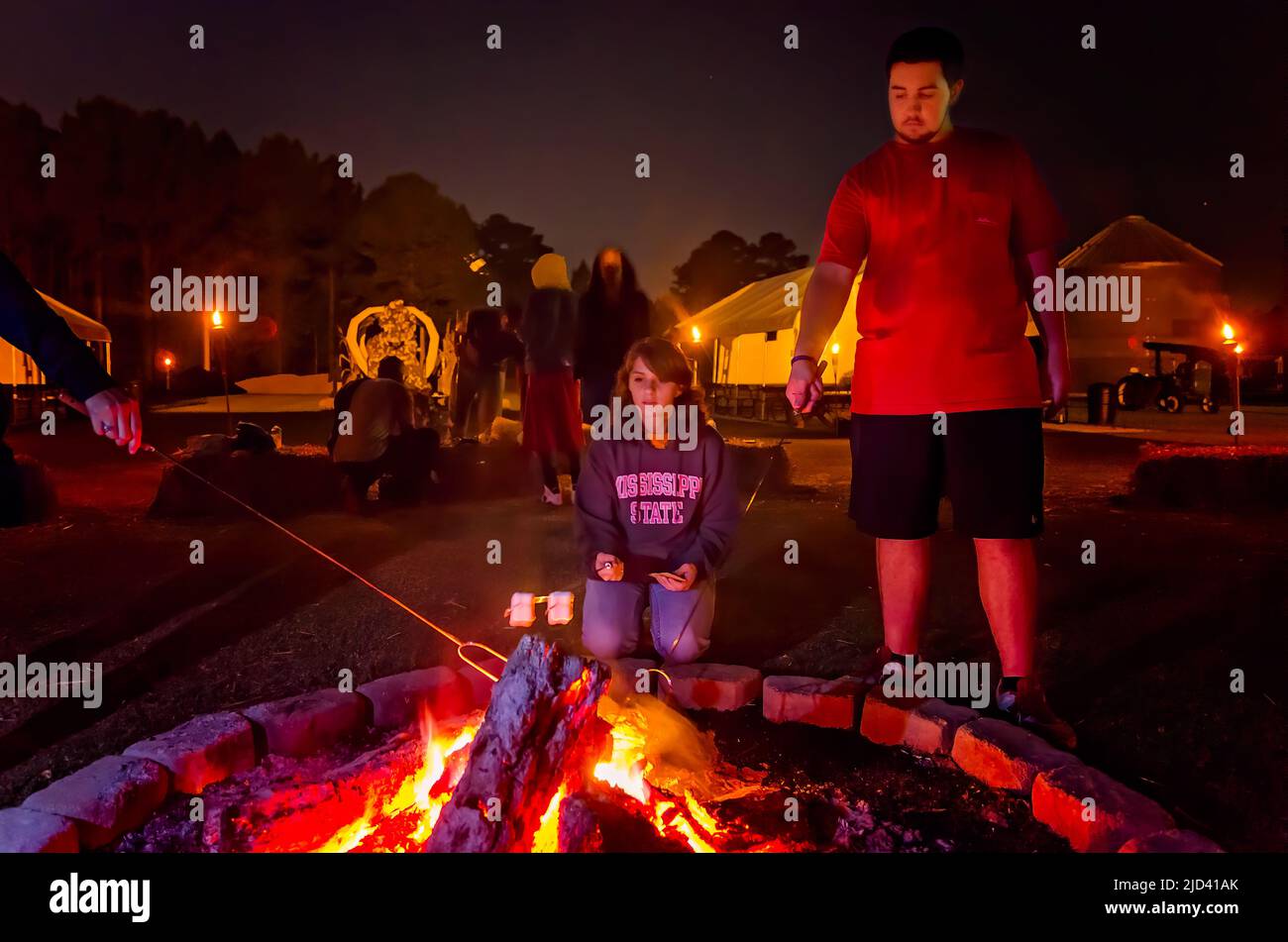 People toast s’mores over a bonfire, Sept. 25, 2012, in Caledonia, Mississippi. S’mores are a popular campfire treat. Stock Photo