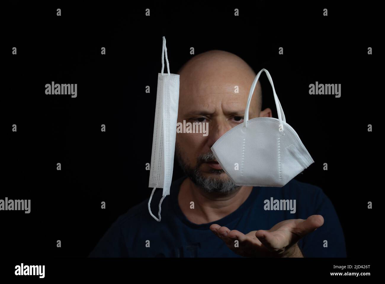Portrait of two protective masks against covid-19 and a man counts on ...