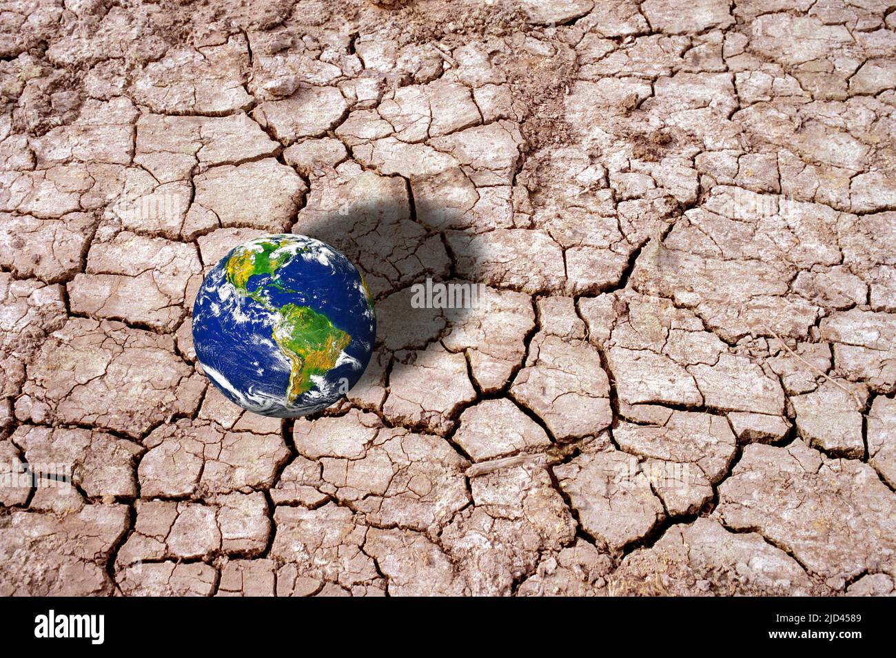 Planet Earth on cracked mud, conceptual illustration Stock Photo