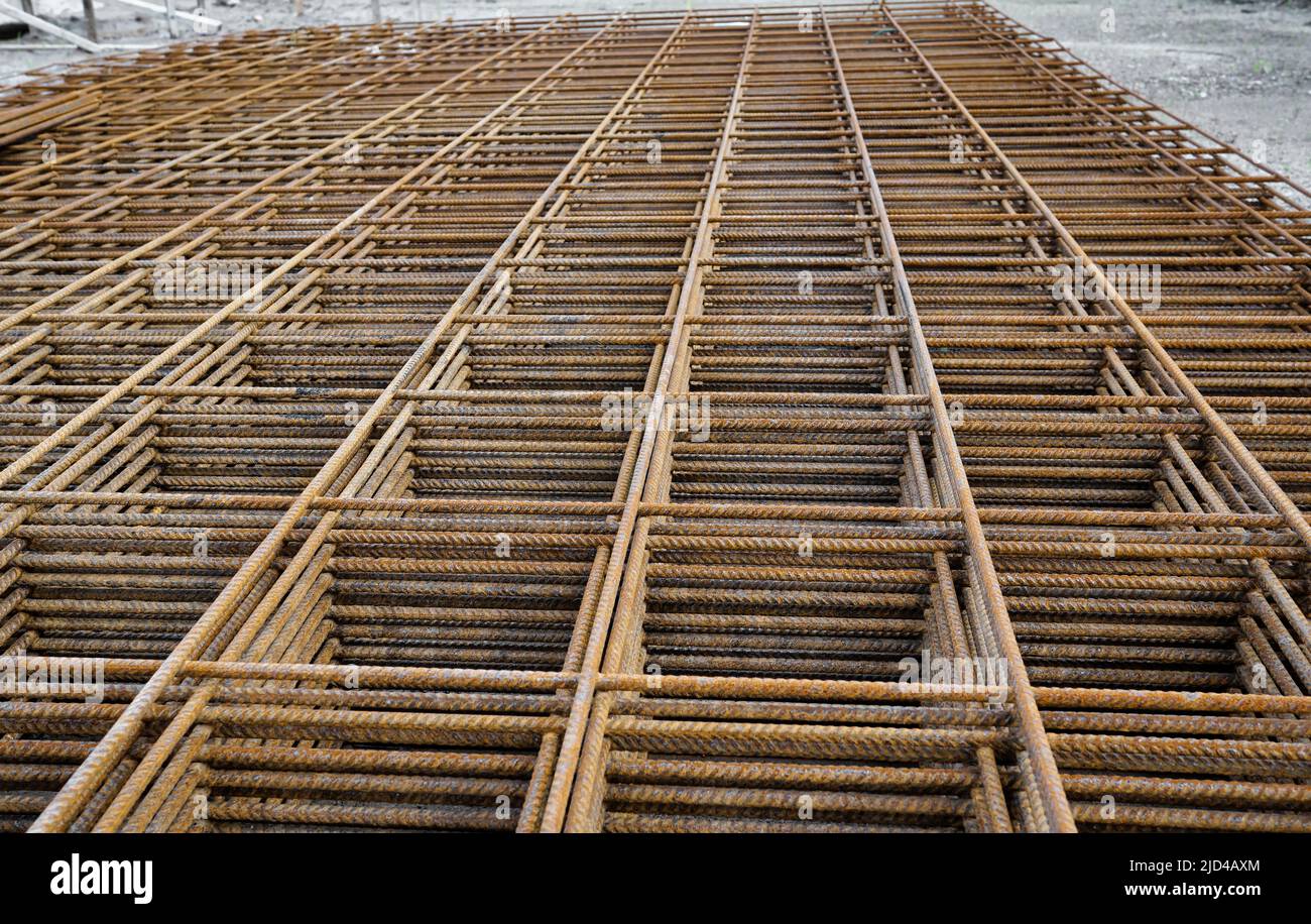 Stacked rusty steel wire mesh for slab concrete work at the construction site Stock Photo