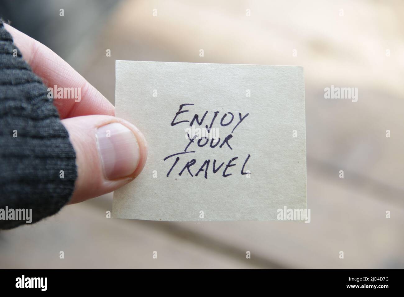 Enjoy your travel idea. The inscription on the tag. Stock Photo