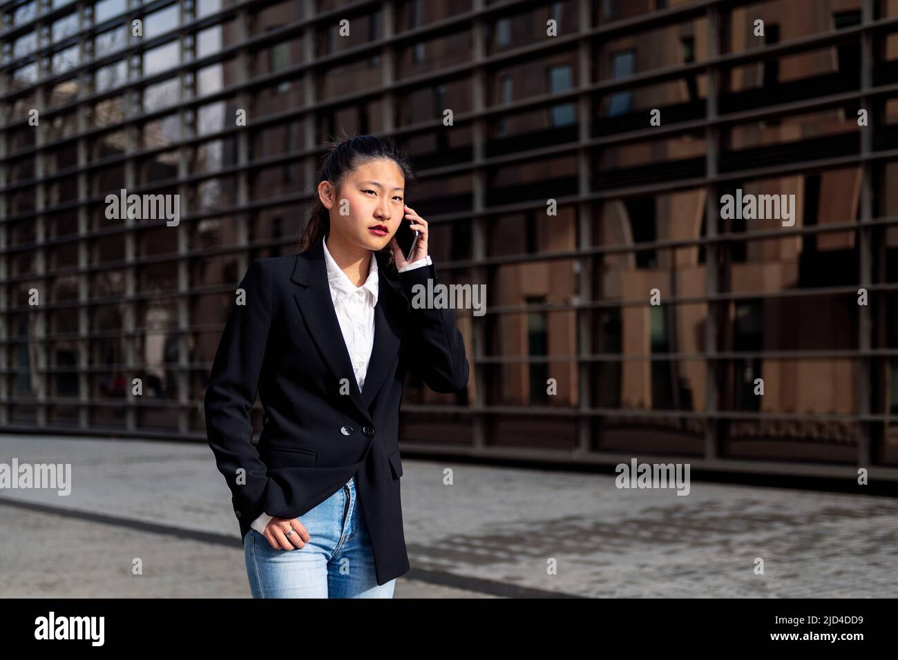 serious asiatic businesswoman talking on the phone Stock Photo