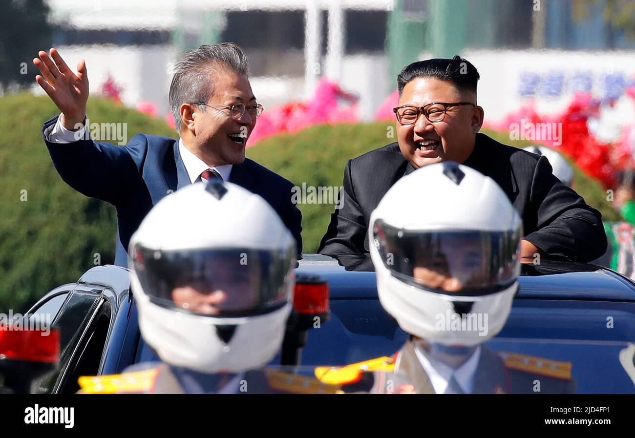 Sep 18, 2018-Pyeongyang, North Korea-South Korean President Moon Jae In and North Korean Leader Kim Jong Un Motorcade parade at Downtown in Pyeongyang, North Korea. The South and North Korean heads of state left Pyeongyang International Airport in separate limousines (as part of a motorcade), exiting their vehicles in front of the Three Revolutions Exhibition Hall to greet Pyeongyang citizens. They then got into the same open top limousine and proceeded in a car parade. After turning left at the Yongheung intersection, the two leaders traveled while waving to the Pyeongyang citizens lining the Stock Photo