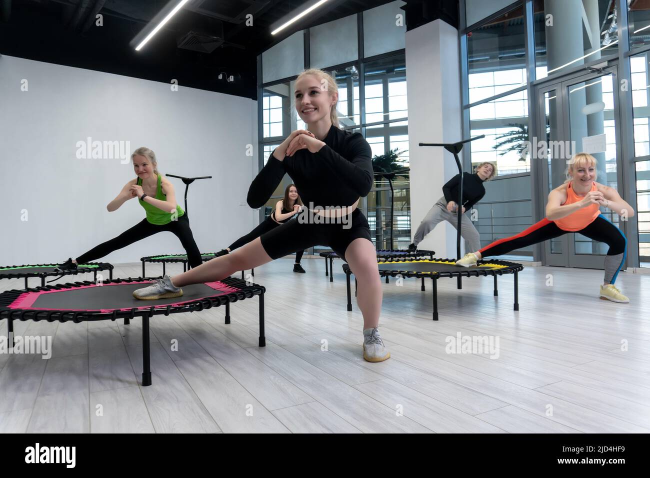 Fitness center group active trampoline friends youth health aerobic training, concept team workout from sport from body indoor, sportswear teamwork Stock Photo