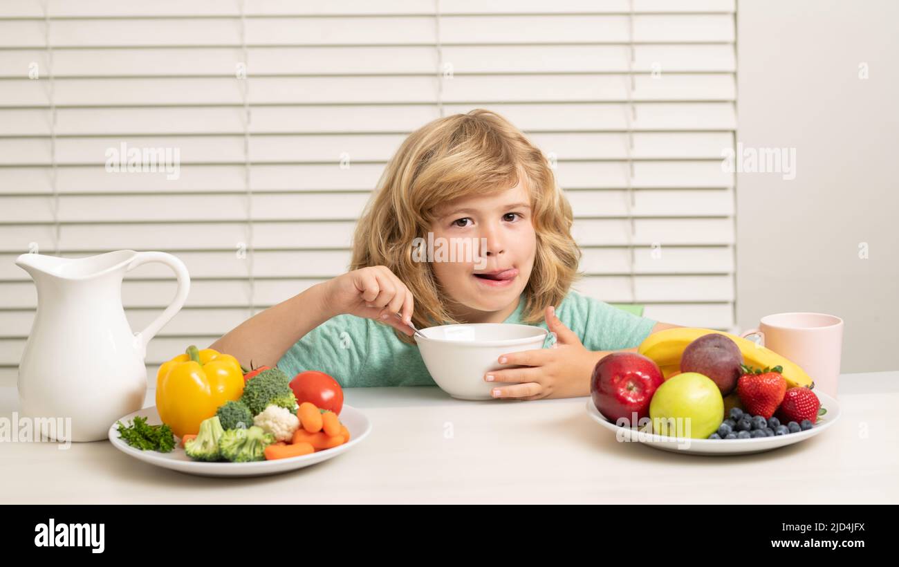 Morning snack with muesli cereal granola. Kid preteen boy in the kitchen at the table eating