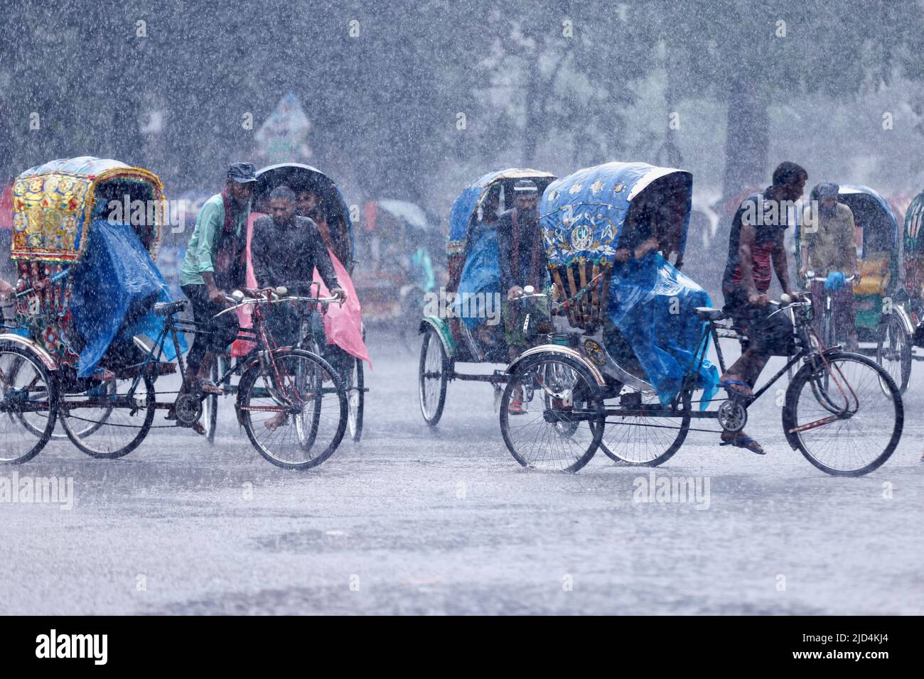 Rickshaws are seen on a street during heavy rains that caused widespread flooding in the northeastern part of the country, in Dhaka, Bangladesh, June 18, 2022. REUTERS/Mohammad Ponir Hossain Stock Photo