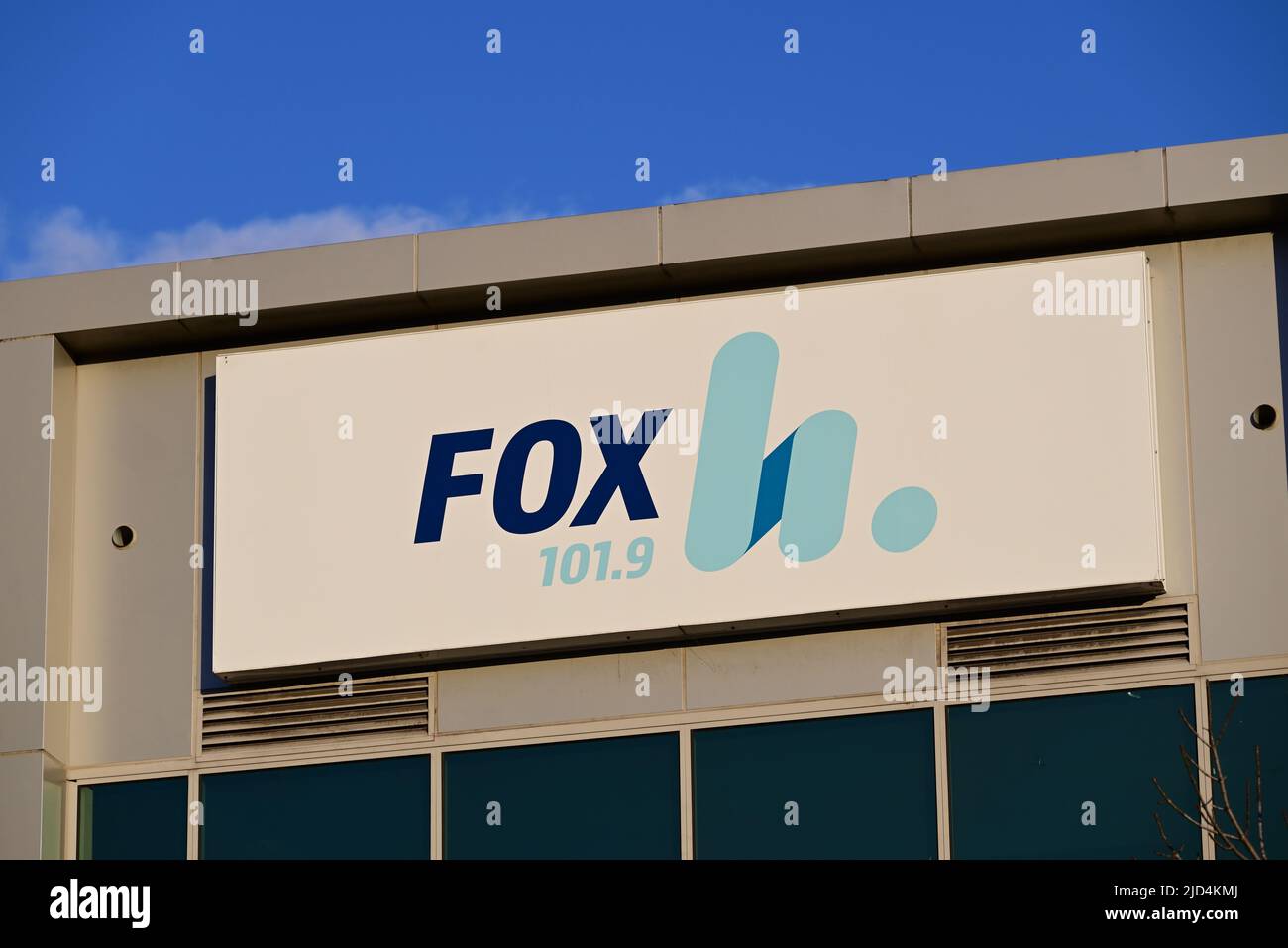 Fox FM radio station sign, featuring the station's logo and frequency, on  the side of their studios building during the late afternoon Stock Photo -  Alamy