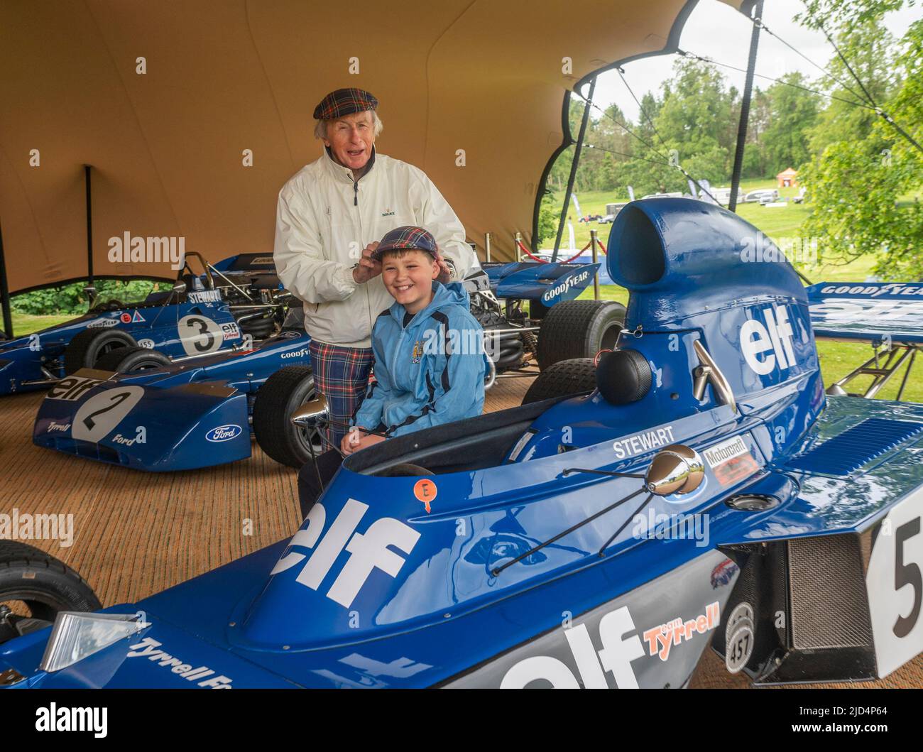 Free first use for this story. 18th June 2022. Thirlestane Castle, Lauder, Scottish Borders. Sir Jackie Stewart pictured with young motorsport fan, Kyle Fenwick-Taylor, 11 from Hawick. Sir Jackie let Kyle try on one of his famous tartan caps while looking at his race cars. Sir Jackie Stewart OBE pictured with Edward Maitland-Carew.who has organised the event at his family home, Thirlestane Castle. PHOTO CAPTION Sir Jackie Stewart OBE is seen outside Thirlestane Castle in the Scottish Borders with his iconic 1969 Matra MS-80 02 which powered him to his first Formula 1 title. The Flyi Stock Photo