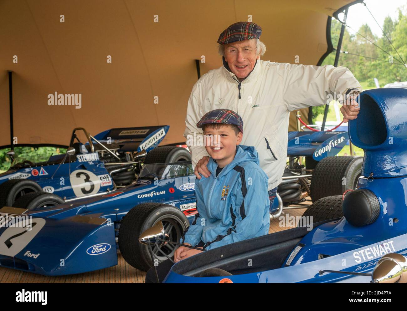Free first use for this story. 18th June 2022. Thirlestane Castle, Lauder, Scottish Borders. Sir Jackie Stewart pictured with young motorsport fan, Kyle Fenwick-Taylor, 11 from Hawick. Sir Jackie let Kyle try on one of his famous tartan caps while looking at his race cars. Sir Jackie Stewart OBE pictured with Edward Maitland-Carew.who has organised the event at his family home, Thirlestane Castle. PHOTO CAPTION Sir Jackie Stewart OBE is seen outside Thirlestane Castle in the Scottish Borders with his iconic 1969 Matra MS-80 02 which powered him to his first Formula 1 title. The Flyi Stock Photo