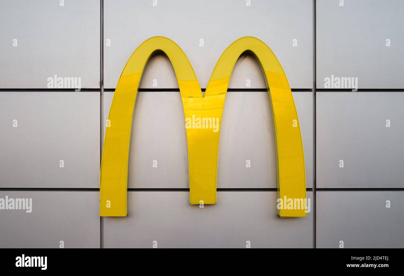McDonald's restauraunt sign. Fast food company logo arches signage. Stock Photo