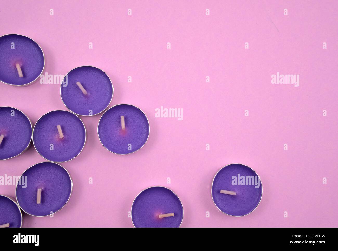 Purple, lavender tealights. Aromatherapy, spa, relaxation, improving psychological well-being style. Stock Photo