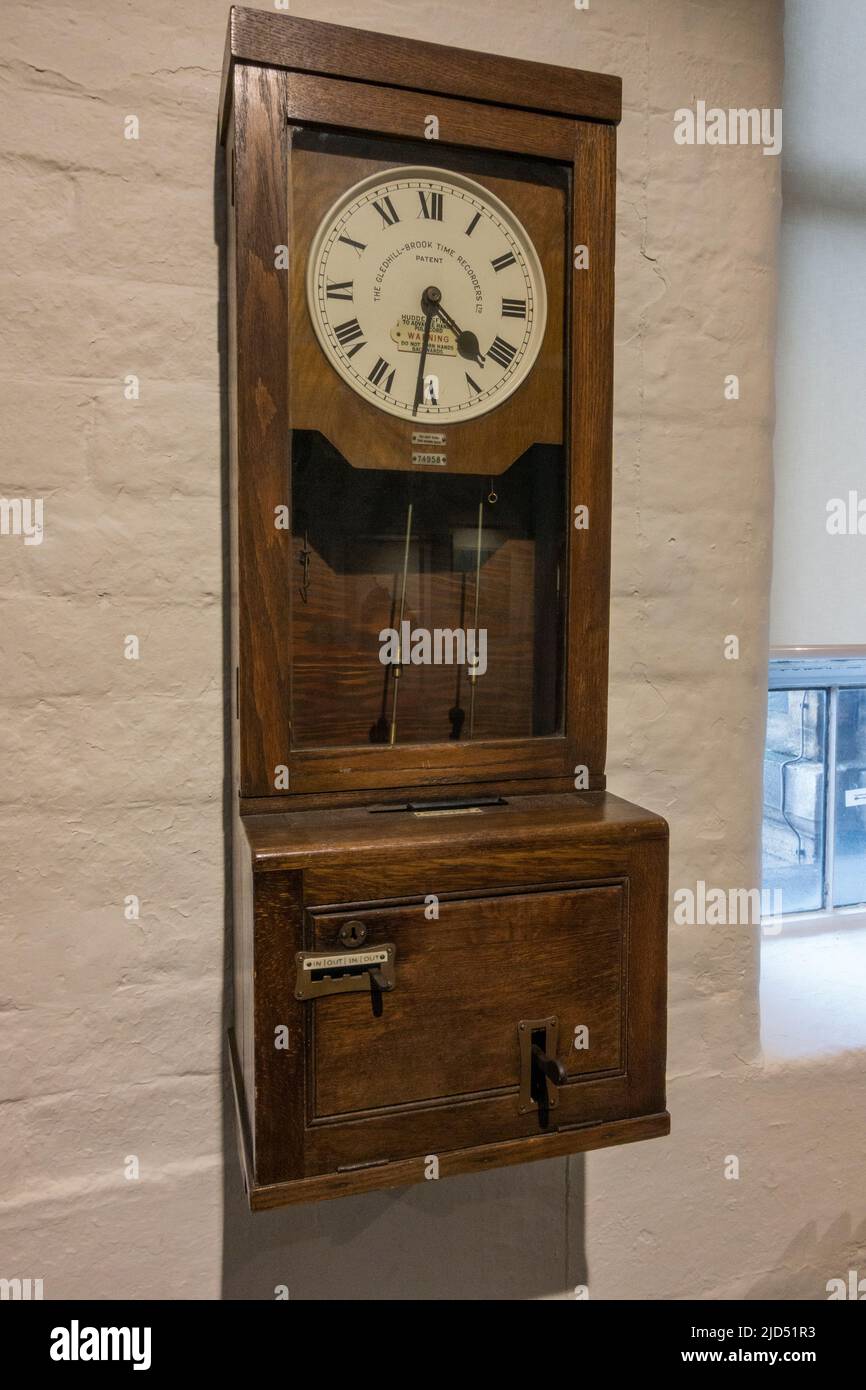 A Gledhill-Brook Time Recorder clocking in/out machine on display in Salts Mill, a former textile mill, in Saltaire, Bradford, W Yorkshire, UK. Stock Photo